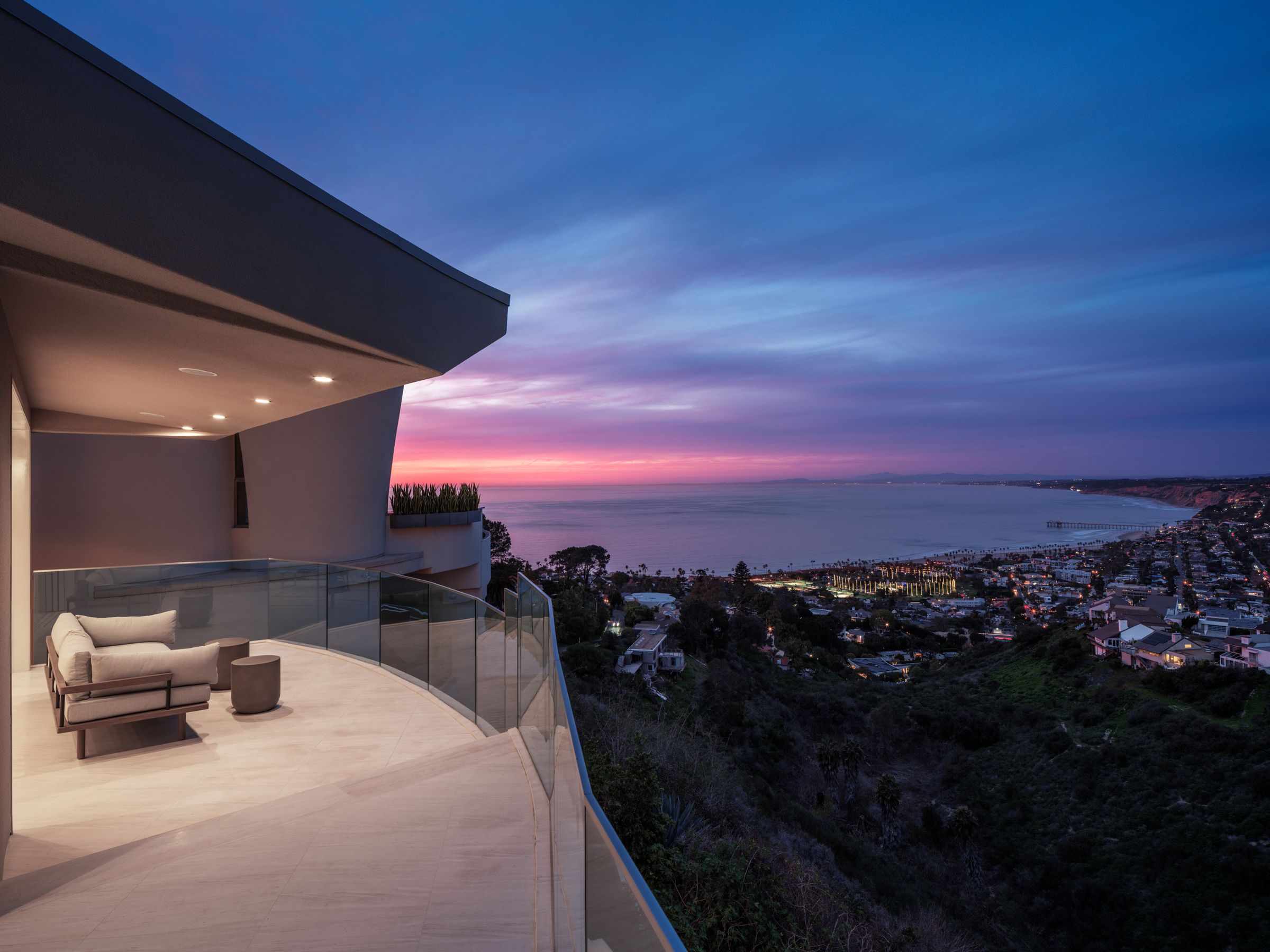 La Jolla vacation rental terrace at dusk overlooking the ocean and the lit coastline